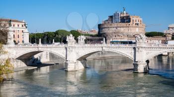Travel to Italy - view of Ponte (bridge) Vittorio Emanuele II on Tiber river and Castle of Holy Angel in Rome city in sunny winter day
