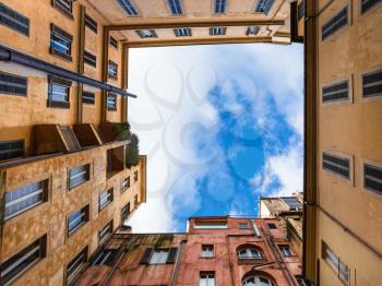 Travel to Italy - bottom view of square sky from pation of urban house in Rome city in winter