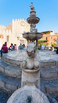 TAORMINA, ITALY - JULY 2, 2011: fountain on Piazza della Cattedrale in Taormina city in Sicily. Baroque fountain with two centaurs and bust of an angel, the symbol of Taormina, it was build in1635