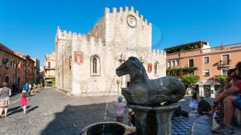 TAORMINA, ITALY - JULY 2, 2011: fountain on piazza del duomo in Taormina city in Sicily. Baroque fountain with two centaurs and bust of an angel, the symbol of Taormina, it was build in1635