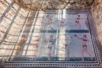 PIAZZA ARMERINA, ITALY - JUNE 29, 2011: Bikini girls mosaic on floor of Villa Romana del Casale. This ancient villa was built in the 4th century and located near Piazza Armerina town in Sicily