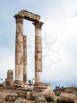 Travel to Middle East country Kingdom of Jordan - columns of Temple of Hercules at Amman Citadel in rainy day in winter