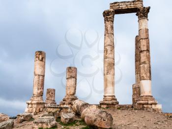 Travel to Middle East country Kingdom of Jordan - ruins of Temple of Hercules at Amman Citadel in rainy day in winter
