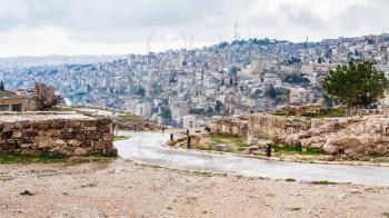 Travel to Middle East country Kingdom of Jordan - wet path from Citadel to Amman city in rain in winter
