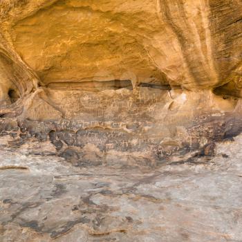 WADI RUM, JORDAN - FEBRUARY 22, 2012: ancient Petroglyphs at stone in Wadi Rum desert. Wadi Rum has been inhabited by many human cultures since prehistoric times.