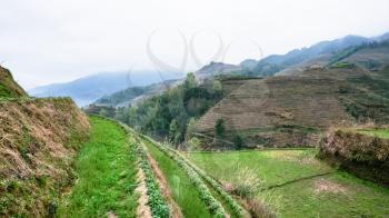 travel to China - terraced fields of Tiantouzhai village on hills in area of Dazhai Longsheng Rice Terraces (Dragon's Backbone terrace, Longji Rice Terraces) in spring season