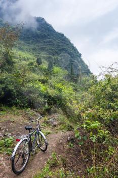 travel to China - bicycle on between mountain peaks in Yangshuo County in spring season