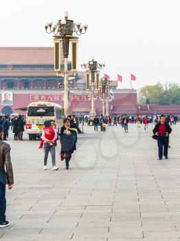 BEIJING, CHINA - MARCH 19, 2017: tourists and loudspeakers on Tiananmen Square in spring. Tiananmen Square is central city square in Beijing