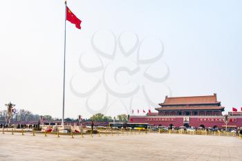 BEIJING, CHINA - MARCH 19, 2017: view of Tiananmen Square with guard of honor near the State Flag, tourists and The Tiananmen monument (Gate of Heavenly Peace) on in spring.