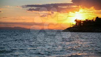 travel to Greece - yellow sunset on Saronic Gulf of Aegean Sea in Athens city