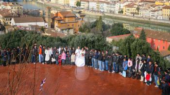 FLORENCE, ITALY - JANUARY 8, 2016: guests on wedding ceremony on Piazzale Michelangelo in Florence city in sunny winter day. Piazzale Michelangelo is very popular viewpoint over town