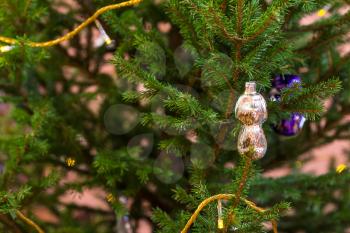 Xmas background - old glass figurine on natural christmas tree indoor