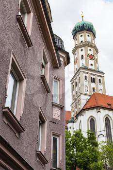 Travel to Germany - towers of SS Ulrich and Afra Church and urban house in Augsburg city in cloudy spring day