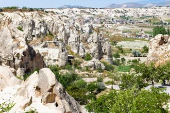 Travel to Turkey - view of valley with fairy chimney rocks and Goreme town in Cappadocia in spring
