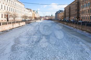 view of frozen Moyka river in Saint Petersburg city in March