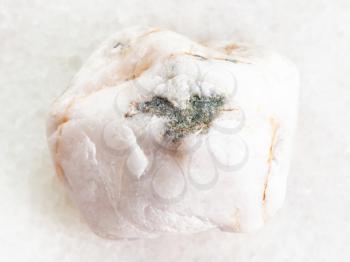 macro shooting of natural mineral rock specimen - white marble gemstone on white marble background from Greece