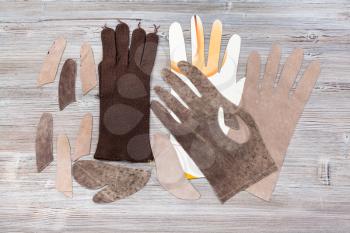 workshop on sewing gloves - top view of set of details for glove production on wooden background