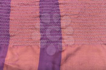 workshop on sewing a patchwork scarf - texture of raw stitched pink silk shawl on table