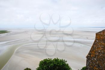 Travel to France - above view of silted fields in low tide near Le Mont Saint-Michel island in Normandy