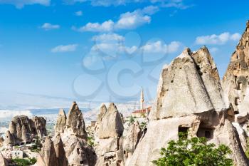 Travel to Turkey - fairy chimney rocks and view of mosque in Uchisar town in Cappadocia in spring