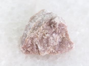 macro shooting of natural mineral rock specimen - raw dolomite stone on white marble background