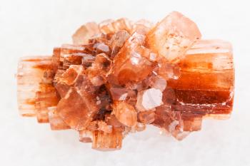 macro shooting of natural mineral rock specimen - raw crystal of Aragonite gemstone on white marble background from Tazouta, Morocco