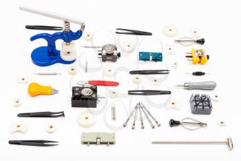 watchmaker workshop - collection of various tools for watch repairing on white background