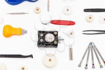 watchmaker workshop - equipment for repairing watch on white background