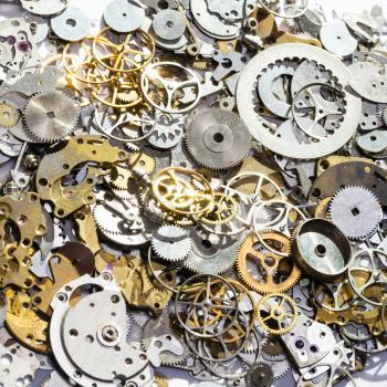 watchmaker workshop - pile of used watch spare parts close up