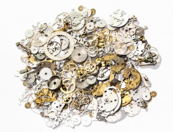 watchmaker workshop - heap of used watch spare parts on white background