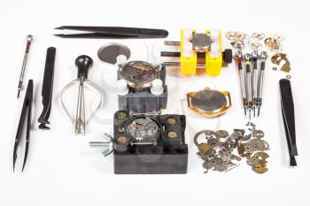 watchmaker workshop - watch repairing tools on white background