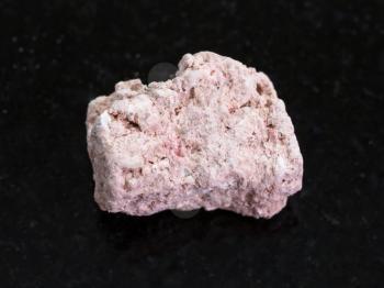 macro shooting of natural mineral rock specimen - raw Kaolinite stone on dark granite background