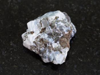 macro shooting of natural mineral rock specimen - raw sphalerite (zinc blende) stone on dark granite background