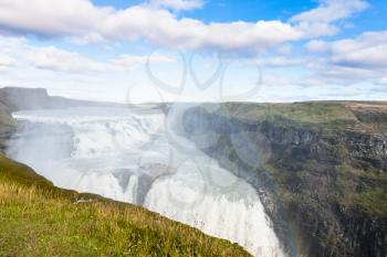 travel to Iceland - rainbow in water spray over Gullfoss waterfall in september