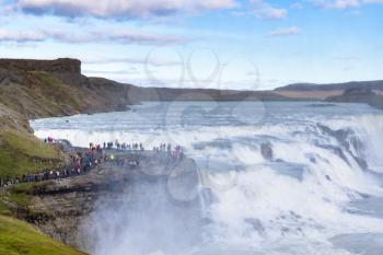 travel to Iceland - view of Gullfoss waterfall and people on observation deck in autumn