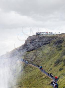 travel to Iceland - people on path to viewpoint over Gullfoss waterfall in september
