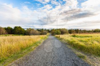 travel to Iceland - dirt road in the vicinity of Reykjavik city in september evening
