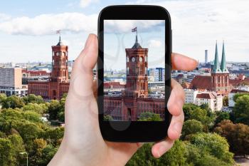 travel concept - tourist photographs Rotes Rathaus (Red City Hall) in Berlin city on smartphone