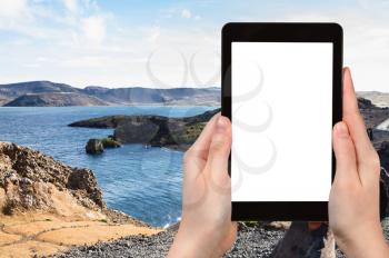 travel concept - tourist photographs Kleifarvatn lake at Southern Peninsula (Reykjanesskagi, Reykjanes Peninsula) in Iceland in september on tablet with cut out screen for advertising logo