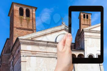 travel concept - tourist photographs Chiesa di San Sebastiano with Tower on Via Giovanni Acerbi in Mantua city in Italy on tablet