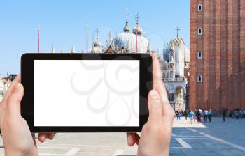travel concept - tourist photograps St Mark's Square (Piazza San Marco) with cathedral, campanile in Venice city in Italy in spring on tablet with cut out screen for advertising logo