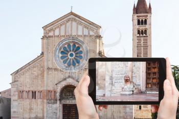 travel concept - tourist photographs Basilica di San Zeno ( San Zeno Maggiore, San Zenone) in Verona city in Italy on tablet