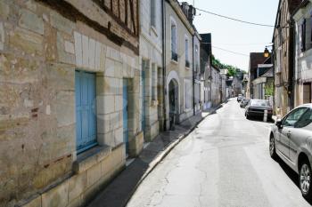 travel to France - residential houses and cars on narrow street Rue Victor Hugo in Amboise town in Val de Loire region in sunny summer day