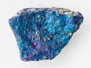 macro shooting of natural mineral rock specimen - blue Chalcopyrite stone on white marble background from Mexico