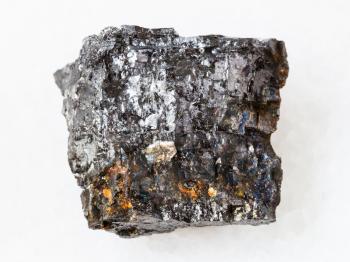 macro shooting of natural mineral rock specimen - raw Bituminous coal stone on white marble background