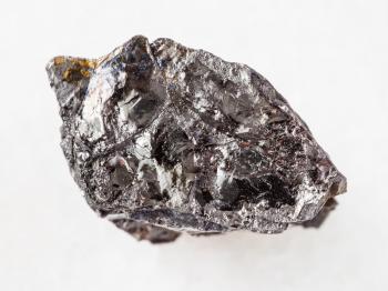 macro shooting of natural mineral rock specimen - piece of Bituminous coal stone on white marble background
