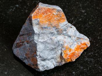 macro shooting of natural rock specimen - rough Hematite ore on black granite background from Brazil