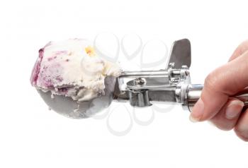 side view of ball of ice cream with blueberries in disher scoop isolated on white backgrouns