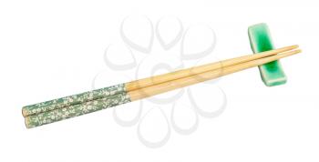 decorated wooden chopsticks served on chopstick rest isolated on white background