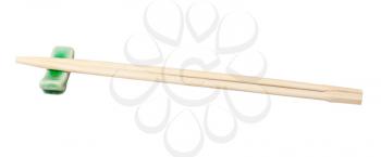 side view of disposable wooden chopsticks served on chopstick rest isolated on white background